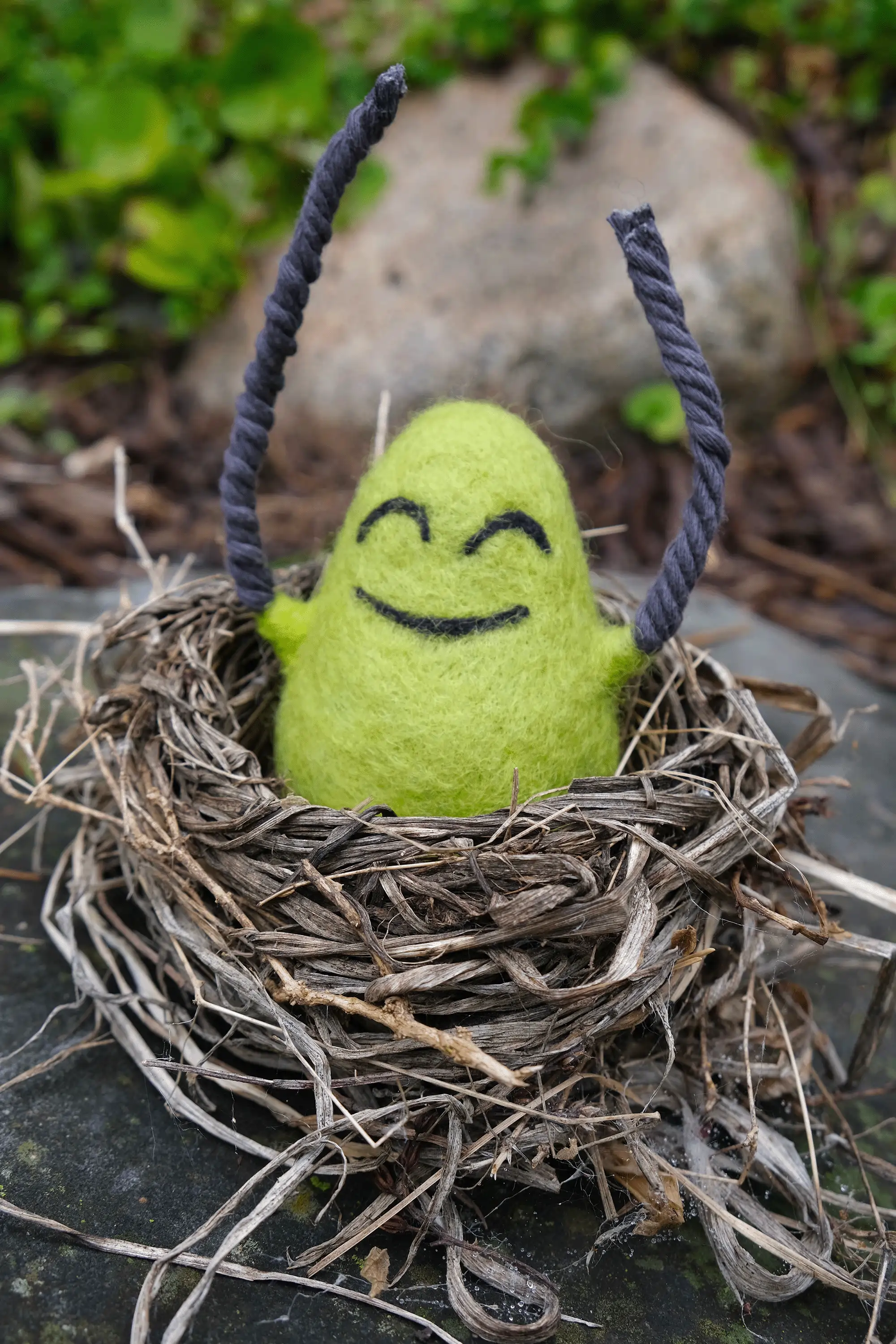 A felted Cloudia hanging out in an abandoned bird nest.