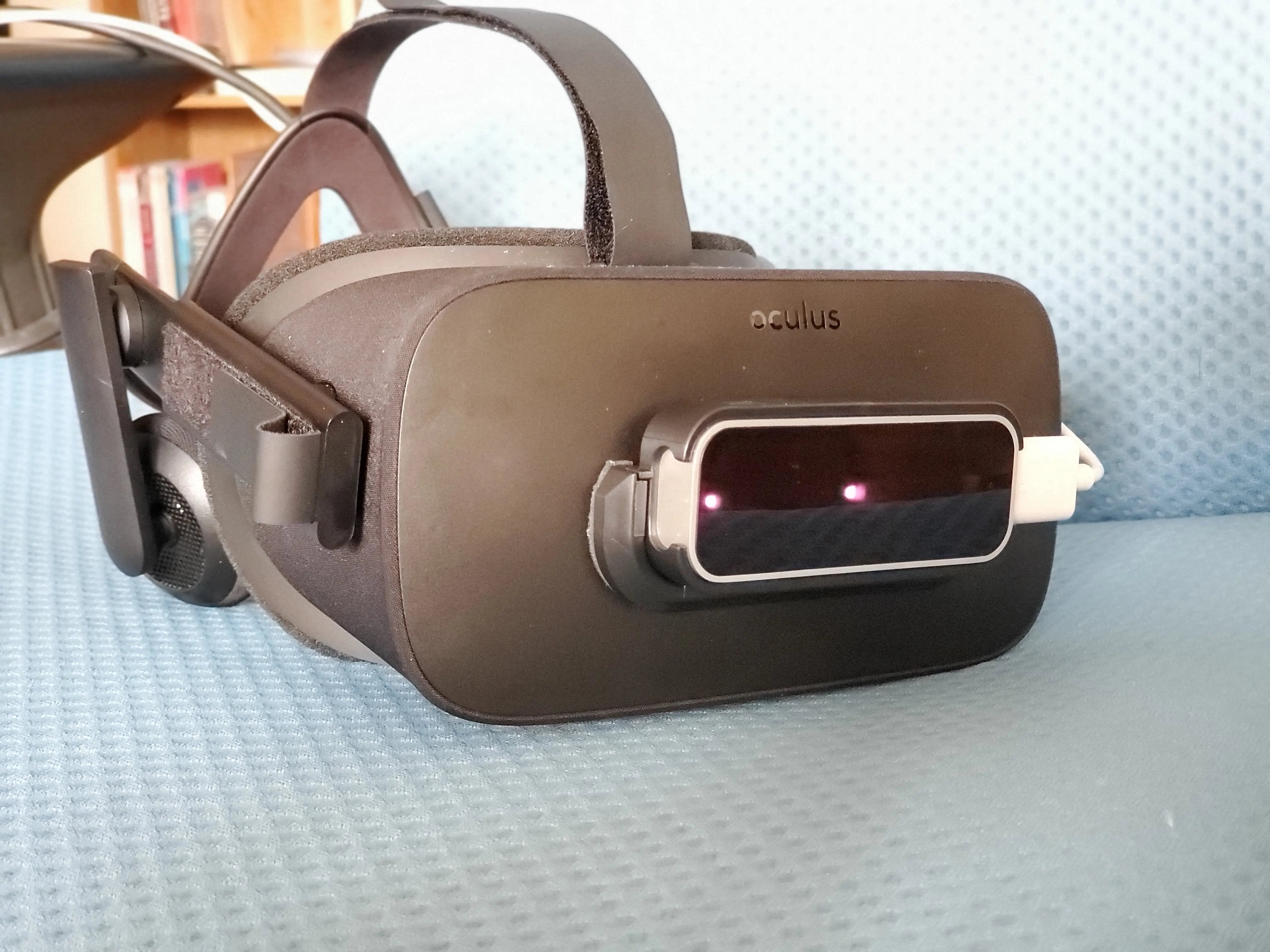 An Oculus Rift with a Leap Motion Controller attached to the front.